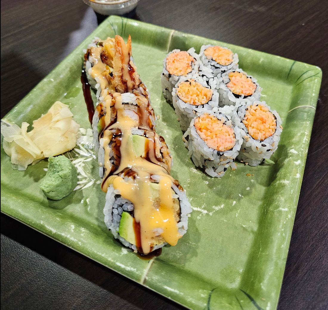 Tempura roll and sushi on a green plate at Arctic Bites